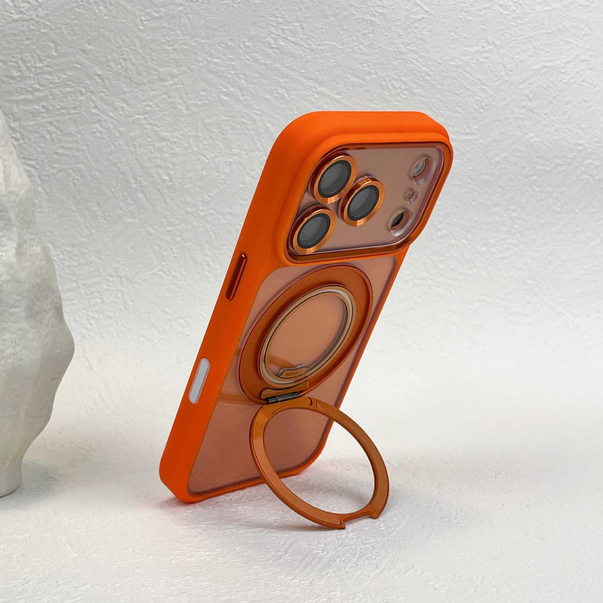 Orange phone case leaning on its folded-out ring stand in portrait position, camera surround at the top