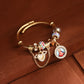 Gold tone cable cuff bangle with clear and multicolour stone beads, heart charm and round portrait medallion