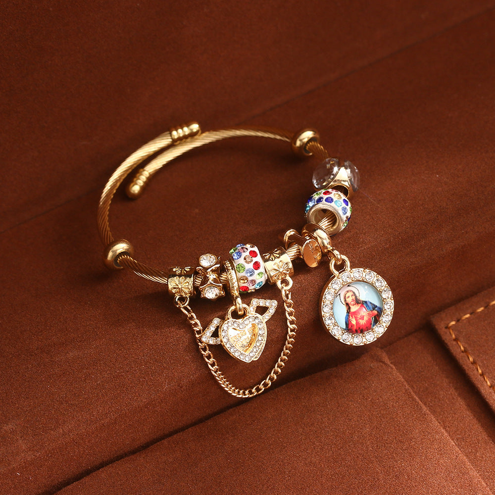 Gold tone cable cuff bangle with clear and multicolour stone beads, heart charm and round portrait medallion