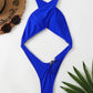Cobalt blue one piece swimsuit laid flat to show the crossover straps and midriff cutout