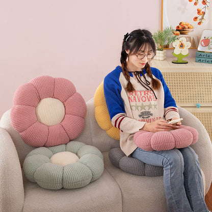 Pink and green flower shaped plush seat cushions on tub chairs in a bright room