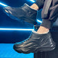 Black molded high top winter boot worn by a model in a blue neon studio