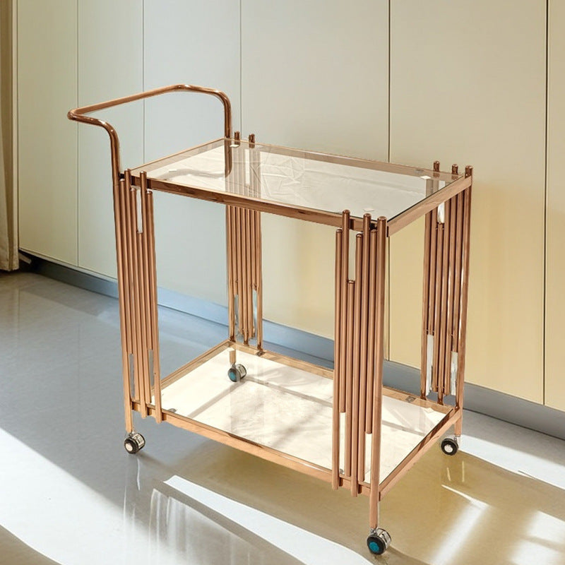 Serving cart on four wheels holding glasses on the upper tempered glass shelf