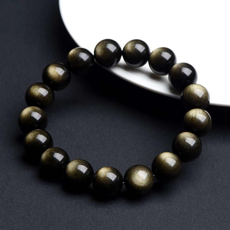 Gold sheen obsidian beaded stretch bracelet with round black beads on grey