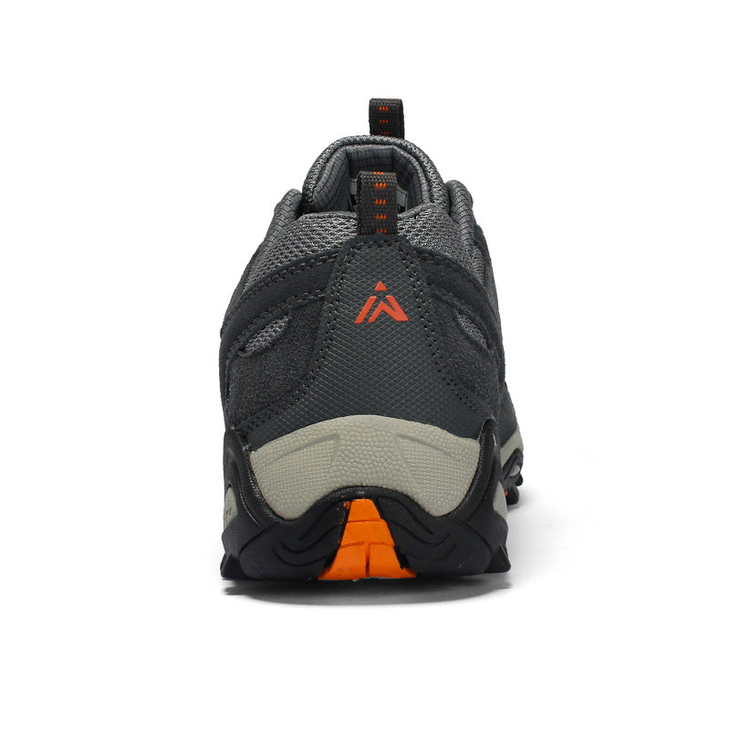 Side view of an outdoor hiking shoe with suede overlays and a grip sole