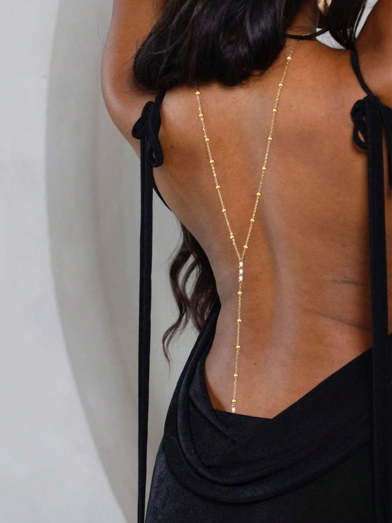 Back drape body chain worn low on a bare back