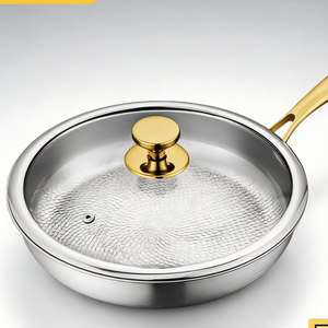 Titanium alloy non-stick frying pan with tempered glass lid and gold handle on a white background