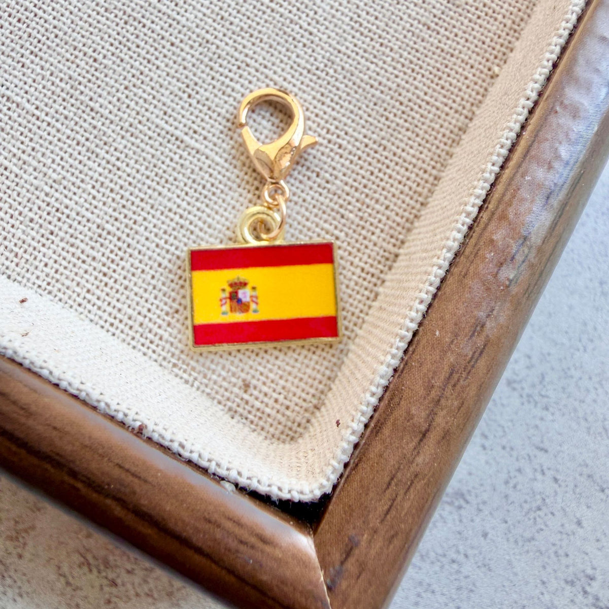 Spain enamel country flag keychain charm on a gold tone lobster clasp for keys and bags