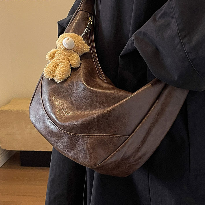 Black PU crossbody dumpling bag with pendant detail