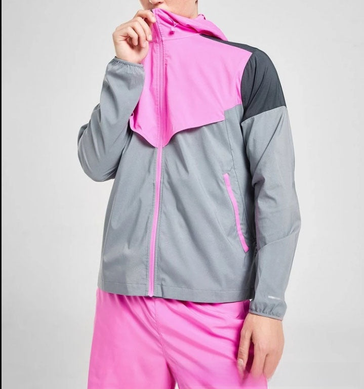 Back view of a colour block hooded sports jacket showing the panel layout on a model