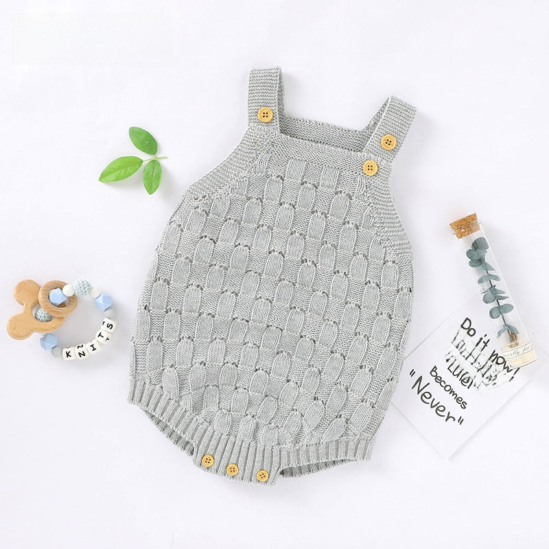 Sleeveless knit baby romper held to show the small infant garment size