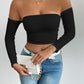 Black off shoulder long sleeve crop top styled with high rise denim and a white belt