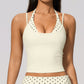 Model in a cropped camisole with a printed halter inset, ivory with black polka dots