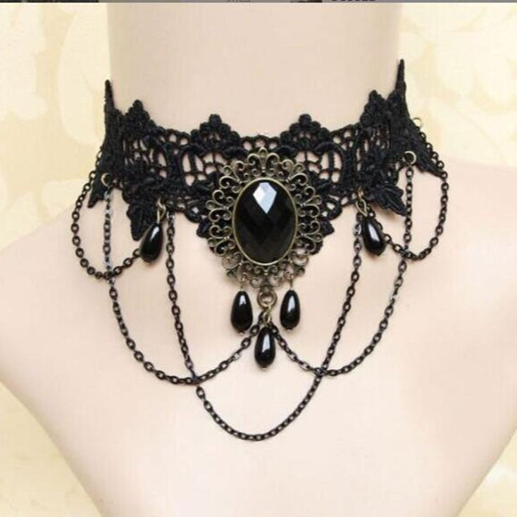 Black lace choker with a faceted cabochon in alloy filigree and teardrop bead swags on a bust