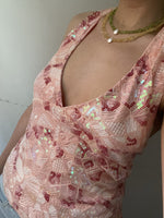Scale reference of the sleeveless sequin V-neck top on a model