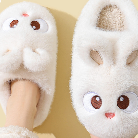 White cartoon bunny plush slippers seen from above on a foot, standard style, option photo for size 24/25