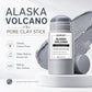 Alaska Volcano pore clay stick on a white podium with a gray clay swatch, icons for deeply cleans pores and refines texture