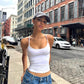 Slim scoop neck cami in a stretch knit worn with low rise jeans