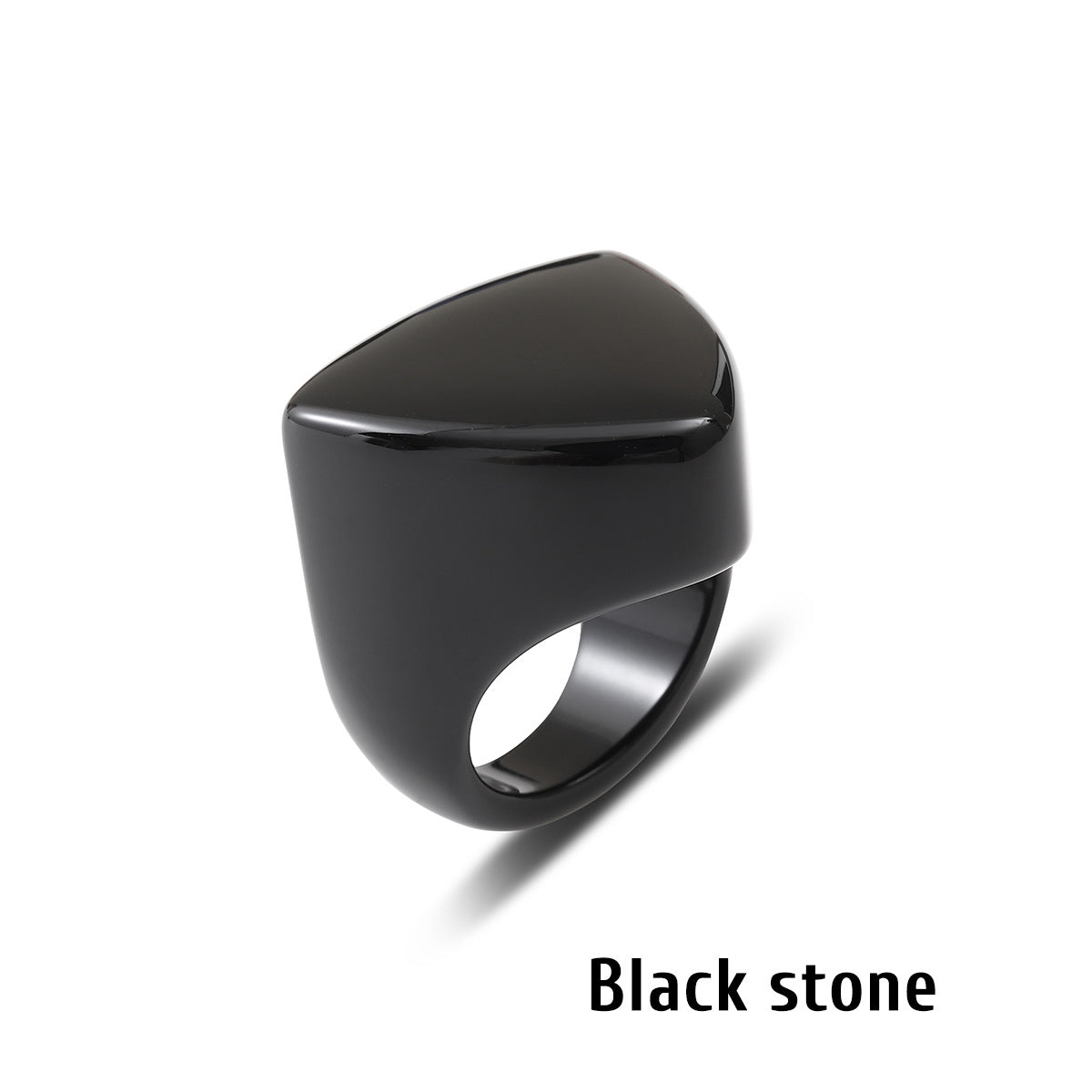 Black stone ring with an angular geometric face on a white background