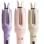 Three automatic hair curlers in purple, pink and cream, rotating chamber tops and lit heat screens
