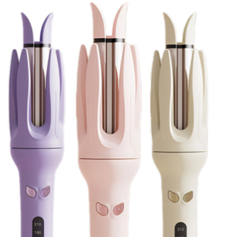 Three automatic hair curlers in purple, pink and cream, rotating chamber tops and lit heat screens