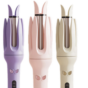 Three automatic hair curlers in purple, pink and cream, rotating chamber tops and lit heat screens
