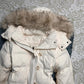 Close view of the furry hood trim and the quilted shoulder of the white jacket