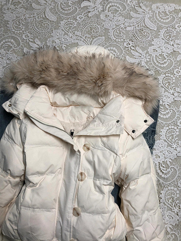 Close view of the furry hood trim and the quilted shoulder of the white jacket