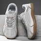Light gray mesh lace-up sneakers with a gum brown flat sole on a concrete block, size 46 option photo