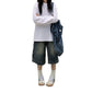 Cropped jeans styled with a tucked linen tee and low leather boots