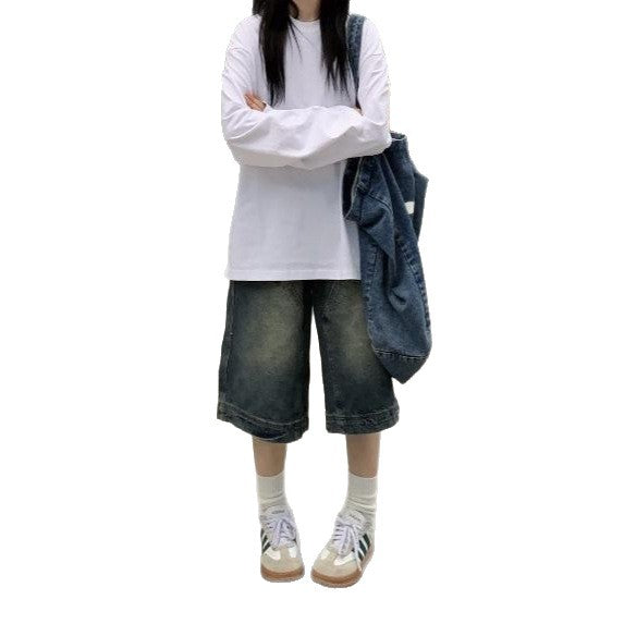 Cropped jeans styled with a tucked linen tee and low leather boots
