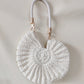 Handmade Woven Conch Shell Coin Purse | soft lighting studio shot