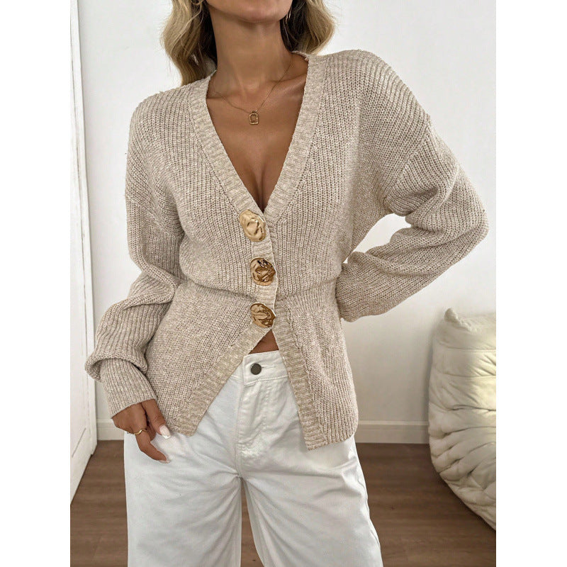 Apricot knit cardigan showing the cinched ribbed waist and long balloon sleeves