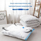 Clear vacuum compression bag holding a white duvet on a bed beside folded bedding