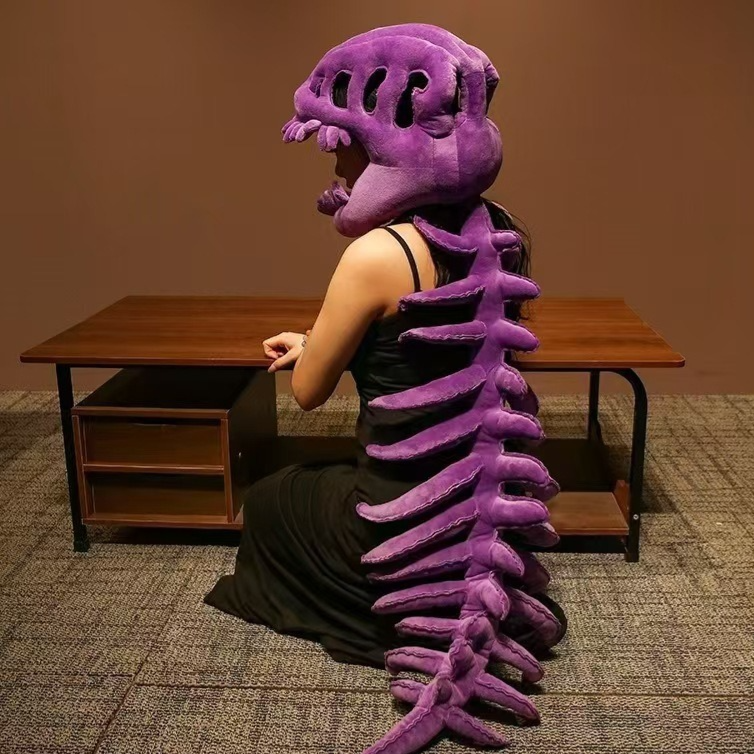 Person in a purple plush dinosaur skeleton head mask with a long purple spine down the back