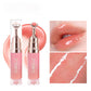 Lip glaze tube with rose gold metal applicator tip and a high shine lip swatch