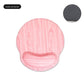 Round mouse pad with a raised memory foam wrist rest seen from the side