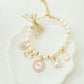 White faux pearl beaded collar for small dogs with dangling gold tone charms and a bell