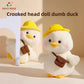 Two cream duck plush toys wearing yellow bucket hats and small brown satchels