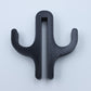 Black resin double hook with an arm on each side, seen from the front on a light background
