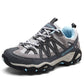 Outdoor lace up hiking shoe shown from the front with orange accents