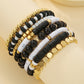 Beaded bracelet stack worn during a daily moment showing layered rows of beads