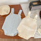 Baby wearing the knitted suspender set in a cozy layered look