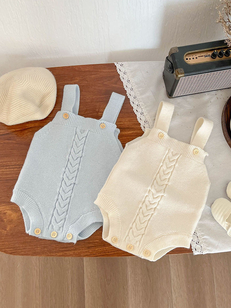 Baby wearing the knitted suspender set in a cozy layered look