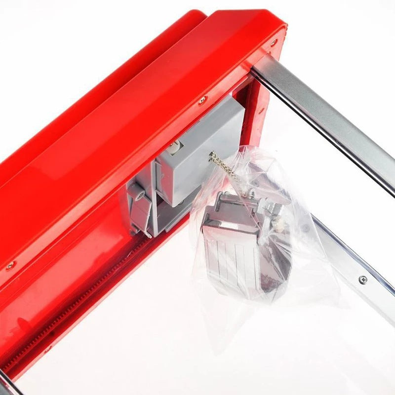 Close up of the claw and its chain inside the red roofed cabinet, wrapped in a clear plastic bag