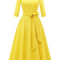 Yellow vintage swing dress with three quarter sleeves and a tie bow belt at the waist