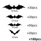 Black bat and spider wall stickers spread across a pale wall surface