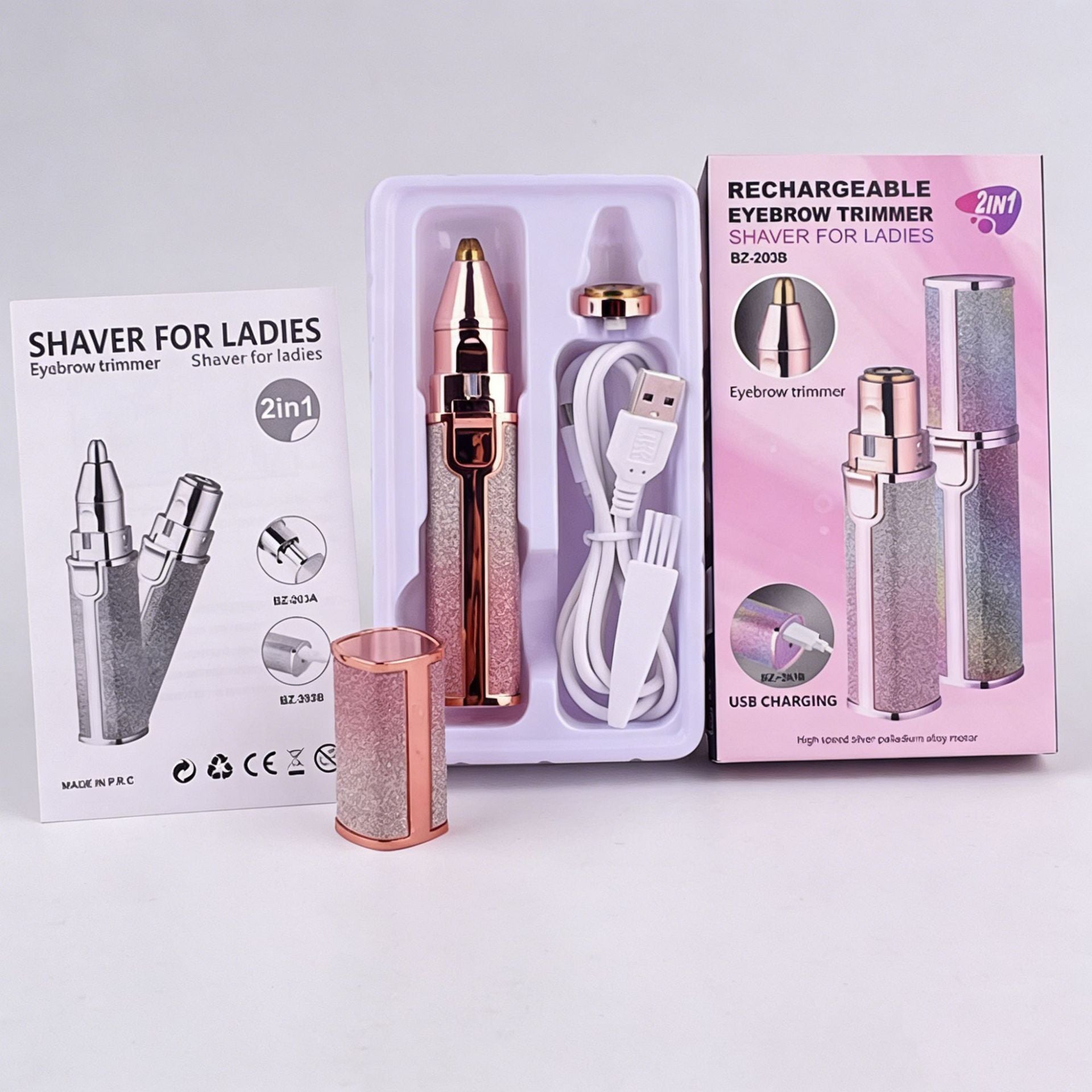 Gradient ladies shaver with cleaning brush next to shaver and trimmer boxes
