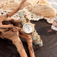 Tiger eye stone beaded quartz watch shown at an angle on a dark wood surface