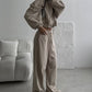 Khaki zip-up hoodie and wide leg trousers set worn by a woman, option photo for size S
